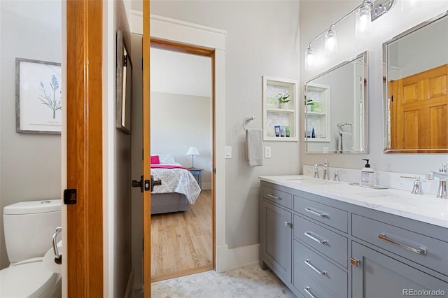 9 Amaranth Dr, Littleton, CO 80127 - ensuite bathroom featuring toilet, ensuite bathroom, double vanity, and a sink