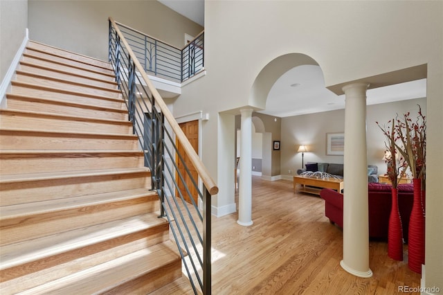 9 Amaranth Dr, Littleton, CO 80127 - stairway with decorative columns, wood finished floors, and baseboards