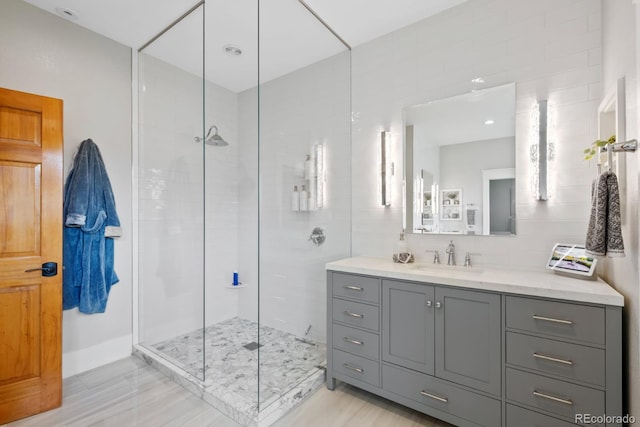 9 Amaranth Dr, Littleton, CO 80127 - bathroom featuring a stall shower, vanity, and tile walls