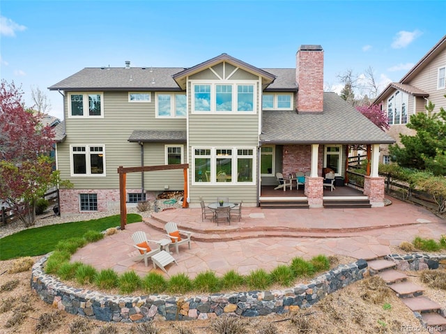 9 Amaranth Dr, Littleton, CO 80127 - rear view of property featuring a chimney, a shingled roof, and a patio area