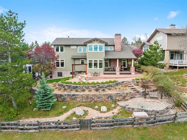 9 Amaranth Dr, Littleton, CO 80127 - back of property with a chimney and a patio area