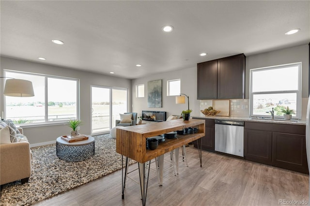 46534 Avery Ln, Bennett, CO 80102 - kitchen featuring dishwasher, open floor plan, light wood-type flooring, a sink, and recessed lighting