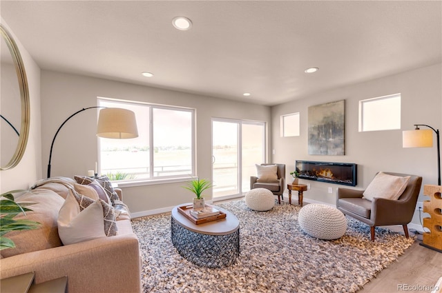 46534 Avery Ln, Bennett, CO 80102 - living room with baseboards, a glass covered fireplace, recessed lighting, and wood finished floors