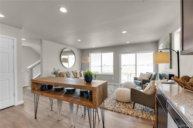 46534 Avery Ln, Bennett, CO 80102 - dining area with light wood-type flooring, recessed lighting, baseboards, and stairs