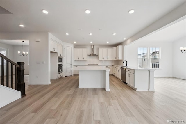 24768 E 40th Ave, Aurora, CO 80019 - kitchen with a chandelier, appliances with stainless steel finishes, wall chimney exhaust hood, light countertops, and recessed lighting