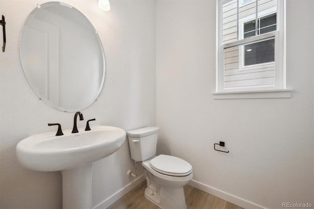 24768 E 40th Ave, Aurora, CO 80019 - half bath with baseboards, wood finished floors, and toilet