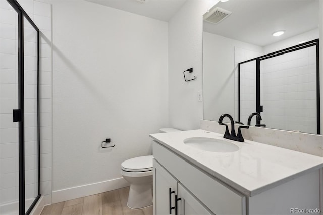 24768 E 40th Ave, Aurora, CO 80019 - full bath featuring wood finished floors, a stall shower, toilet, vanity, and baseboards