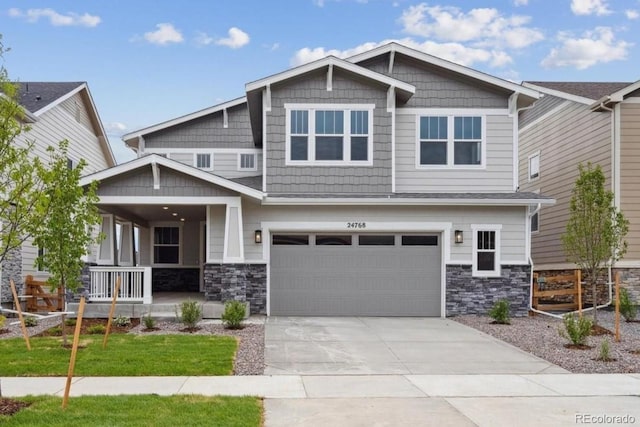24768 E 40th Ave, Aurora, CO 80019 - craftsman-style house featuring covered porch, stone siding, a garage, and concrete driveway