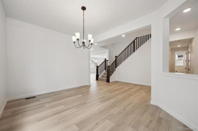 24768 E 40th Ave, Aurora, CO 80019 - unfurnished room featuring plenty of natural light, stairs, a chandelier, recessed lighting, and light wood finished floors