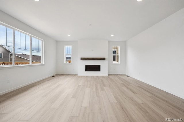 24768 E 40th Ave, Aurora, CO 80019 - unfurnished living room featuring light wood-type flooring, a fireplace, recessed lighting, and baseboards