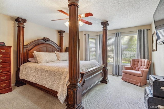 bedroom with light colored carpet, a textured ceiling, and a ceiling fan