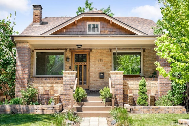 315 S Franklin St, Denver, CO 80209 - view of front of house featuring brick siding, a chimney, and a shingled roof