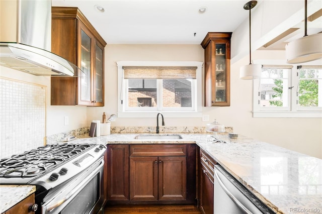 315 S Franklin St, Denver, CO 80209 - kitchen featuring exhaust hood, gas stove, a sink, dishwashing machine, and light stone countertops