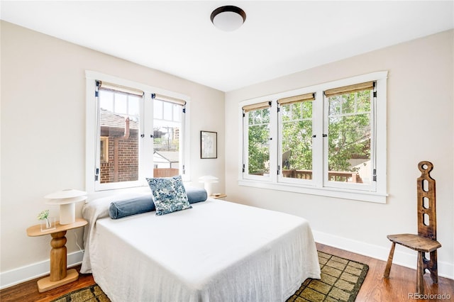 315 S Franklin St, Denver, CO 80209 - bedroom featuring multiple windows, baseboards, and wood finished floors