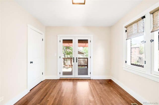 315 S Franklin St, Denver, CO 80209 - empty room featuring wood finished floors, french doors, and baseboards
