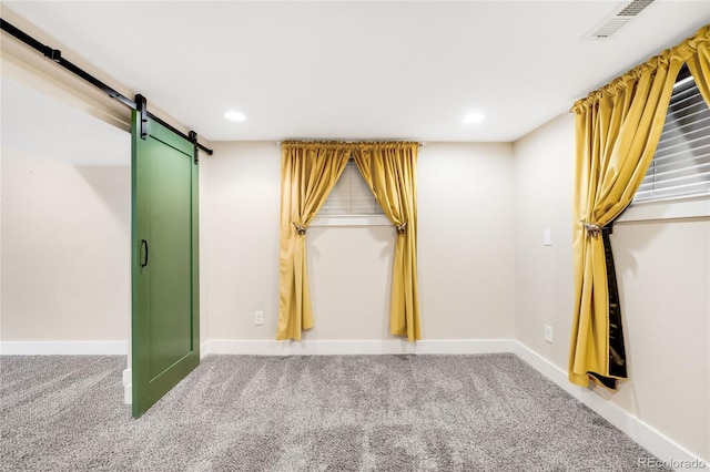 315 S Franklin St, Denver, CO 80209 - carpeted empty room with a barn door, baseboards, and recessed lighting
