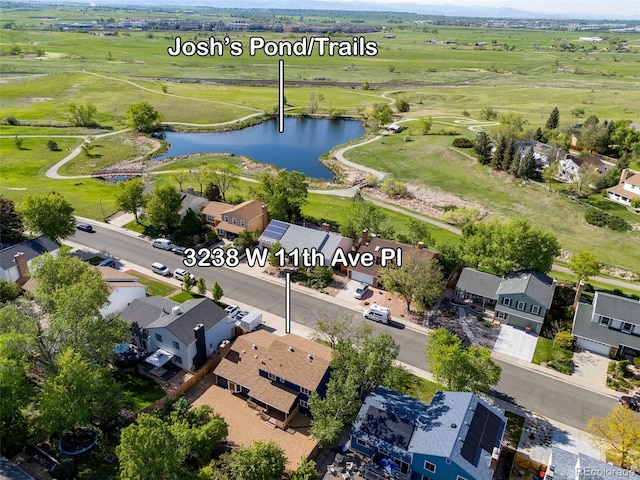 aerial view of property's location featuring a nearby body of water and nearby suburban area