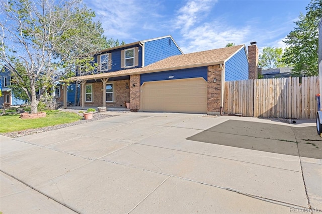 traditional-style home featuring a garage, fence, brick siding, and concrete driveway