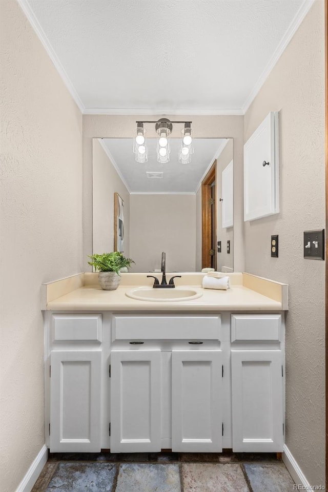 bathroom featuring baseboards, crown molding, and vanity