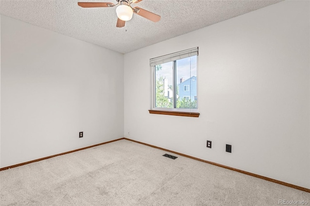 unfurnished room featuring a textured ceiling, carpet, ceiling fan, and baseboards