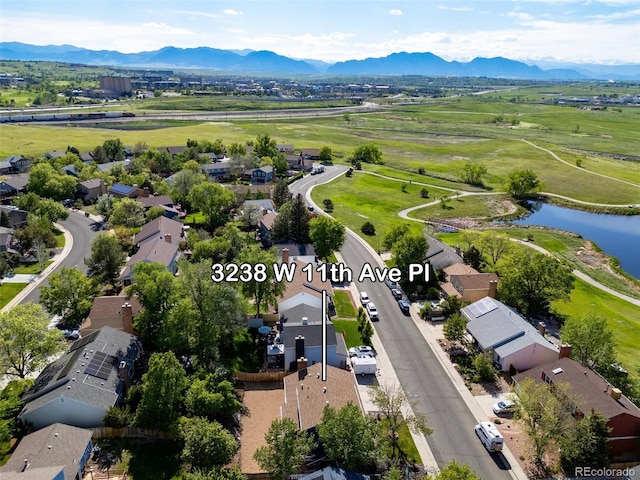 aerial view of residential area featuring a water and mountain view