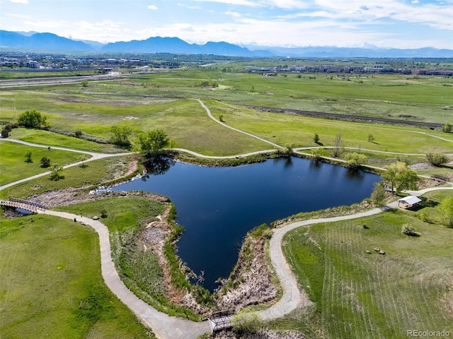 aerial view of sparsely populated area featuring a water and mountain view