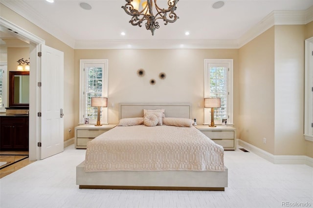 bedroom with ensuite bath, crown molding, and a notable chandelier