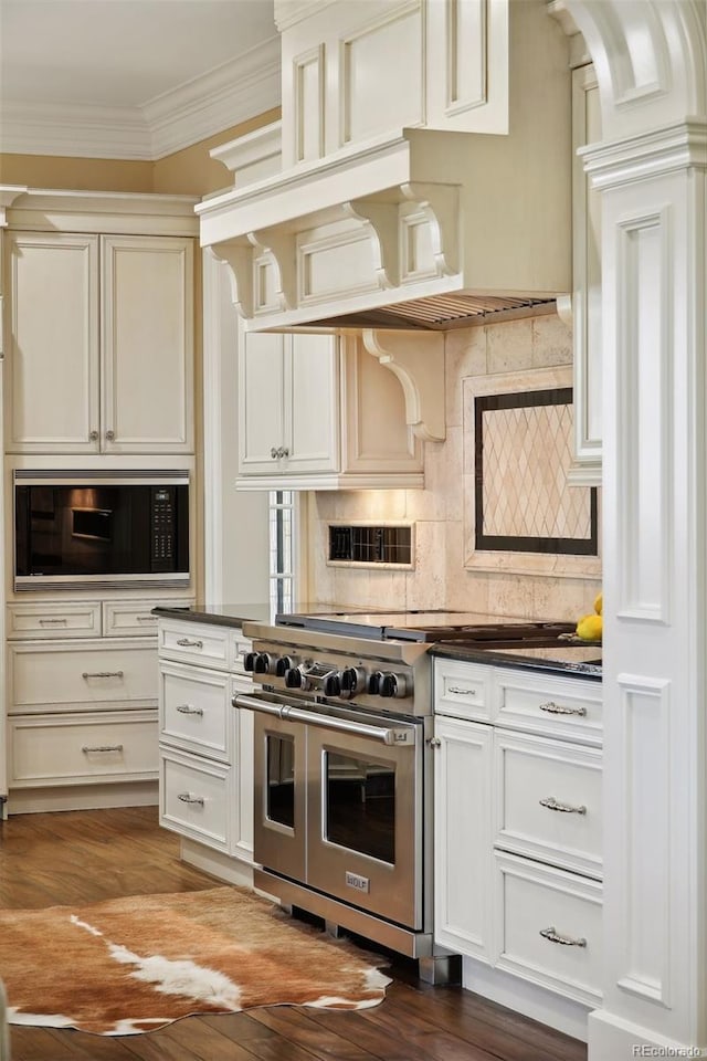 kitchen with ornamental molding, decorative backsplash, appliances with stainless steel finishes, and dark wood-type flooring