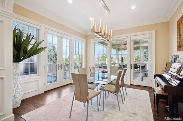 sunroom / solarium featuring a chandelier and french doors