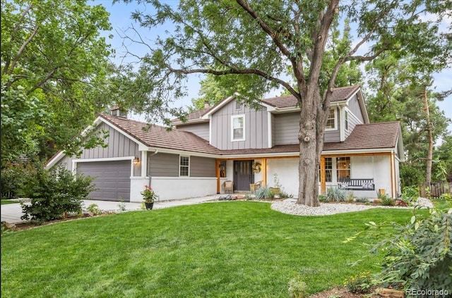 view of front of house featuring a garage, a front yard, and covered porch