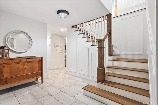 stairway with tile patterned flooring