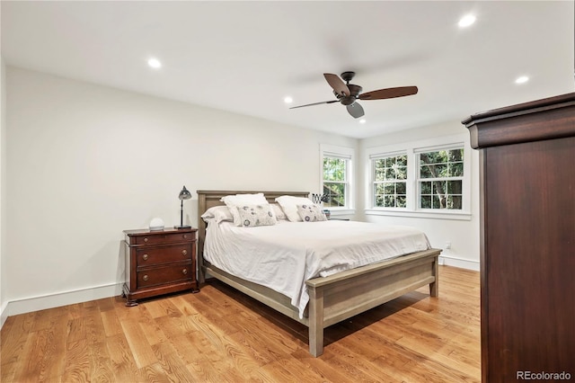 bedroom with ceiling fan and light wood-type flooring