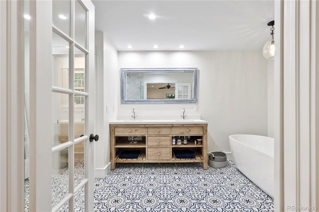 bathroom with vanity and a tub