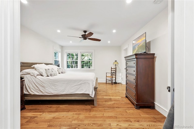 bedroom with ceiling fan and light hardwood / wood-style flooring