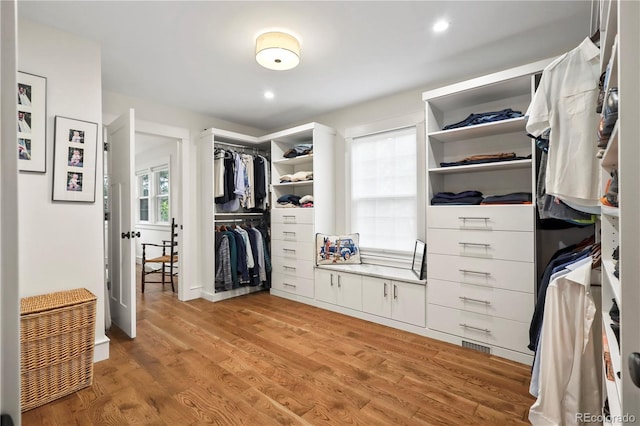 spacious closet with light hardwood / wood-style floors