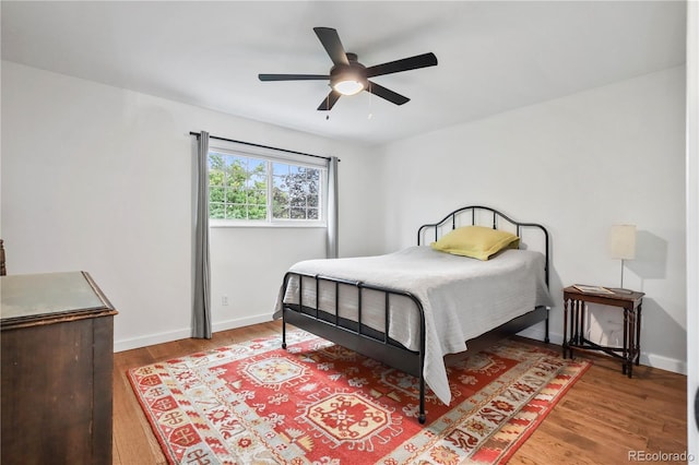 bedroom with ceiling fan and hardwood / wood-style floors