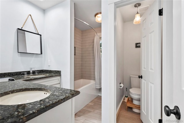 full bathroom featuring vanity, toilet, and shower / bath combo with shower curtain