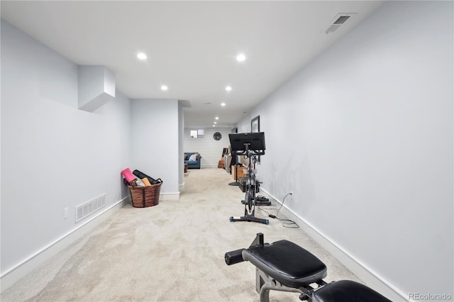 exercise room with light colored carpet