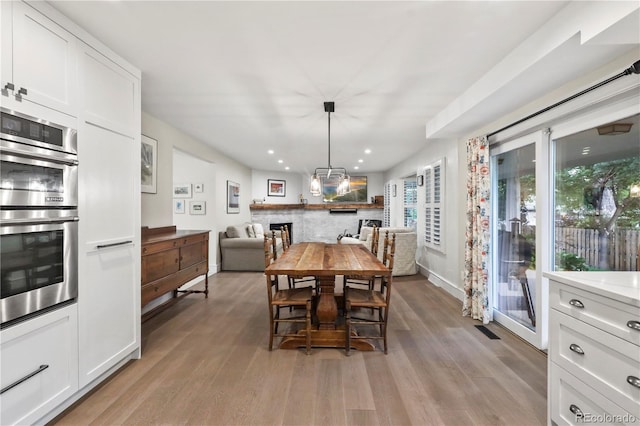 dining space with light hardwood / wood-style flooring