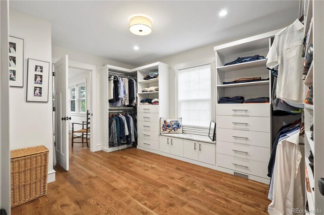 walk in closet featuring light hardwood / wood-style floors