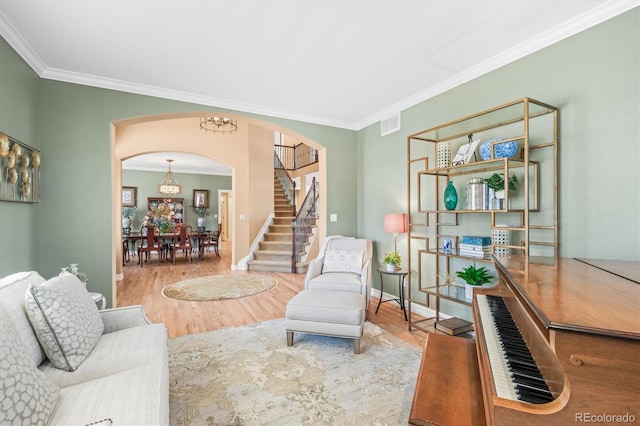 living room with hardwood / wood-style flooring and crown molding