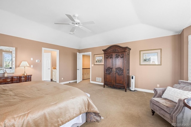 bedroom featuring lofted ceiling, light colored carpet, ceiling fan, and ensuite bathroom