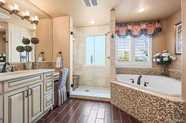 bathroom featuring vanity and separate shower and tub