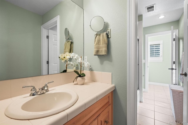 bathroom featuring tile patterned flooring and vanity