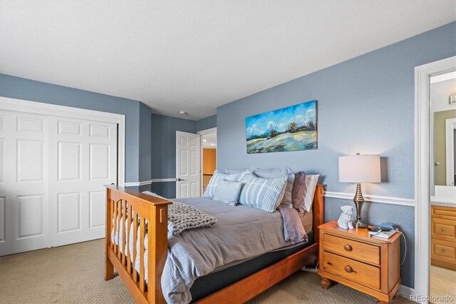 bedroom with light colored carpet and a closet