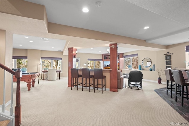 bar with light colored carpet and decorative columns