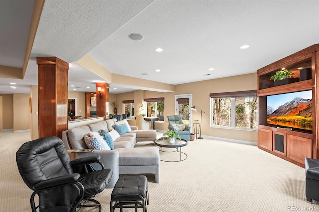 carpeted living room featuring a textured ceiling