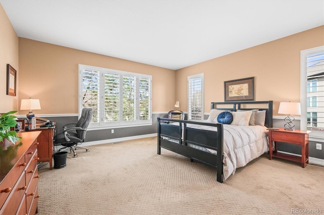 bedroom featuring light carpet and baseboards