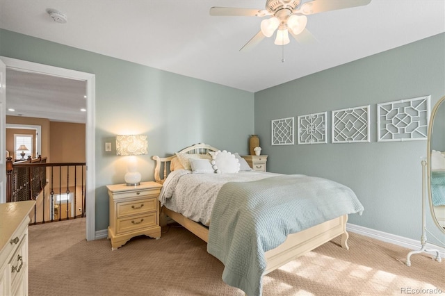 bedroom featuring light colored carpet, ceiling fan, and baseboards