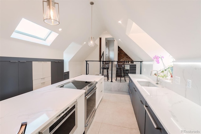 1165 N Pennsylvania St Unit 3B, Denver, CO 80203 - kitchen featuring a skylight, electric stove, a sink, vaulted ceiling, and hanging light fixtures